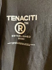 Tenaciti Studios t-shirt features a large fuzzy “T” logo on the right chest SZ S