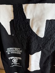 Tenaciti Studios t-shirt features a large fuzzy “T” logo on the right chest SZ S